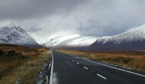 a road with a mountain in the background